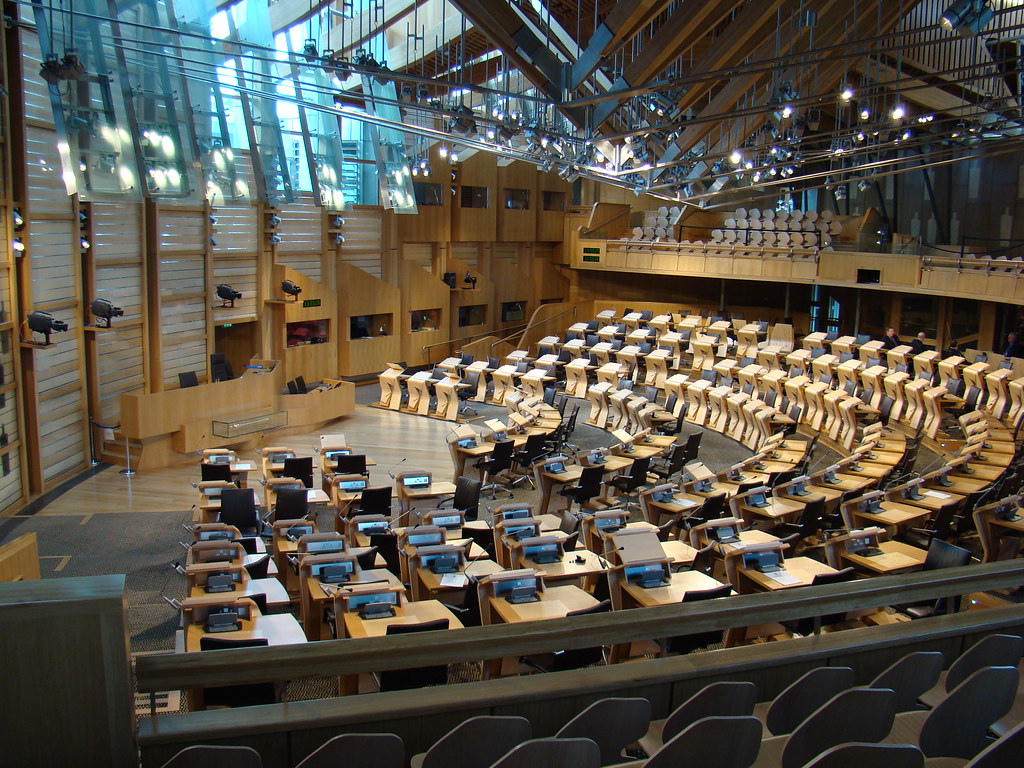 View of the debating chamber at Holyrood, with concentric rings of lecterns around a speaker's podium